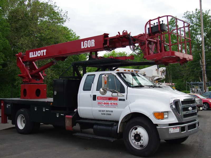 VH crane truck staged in the Woodhaven Road yard with the boom lowered before a morning install