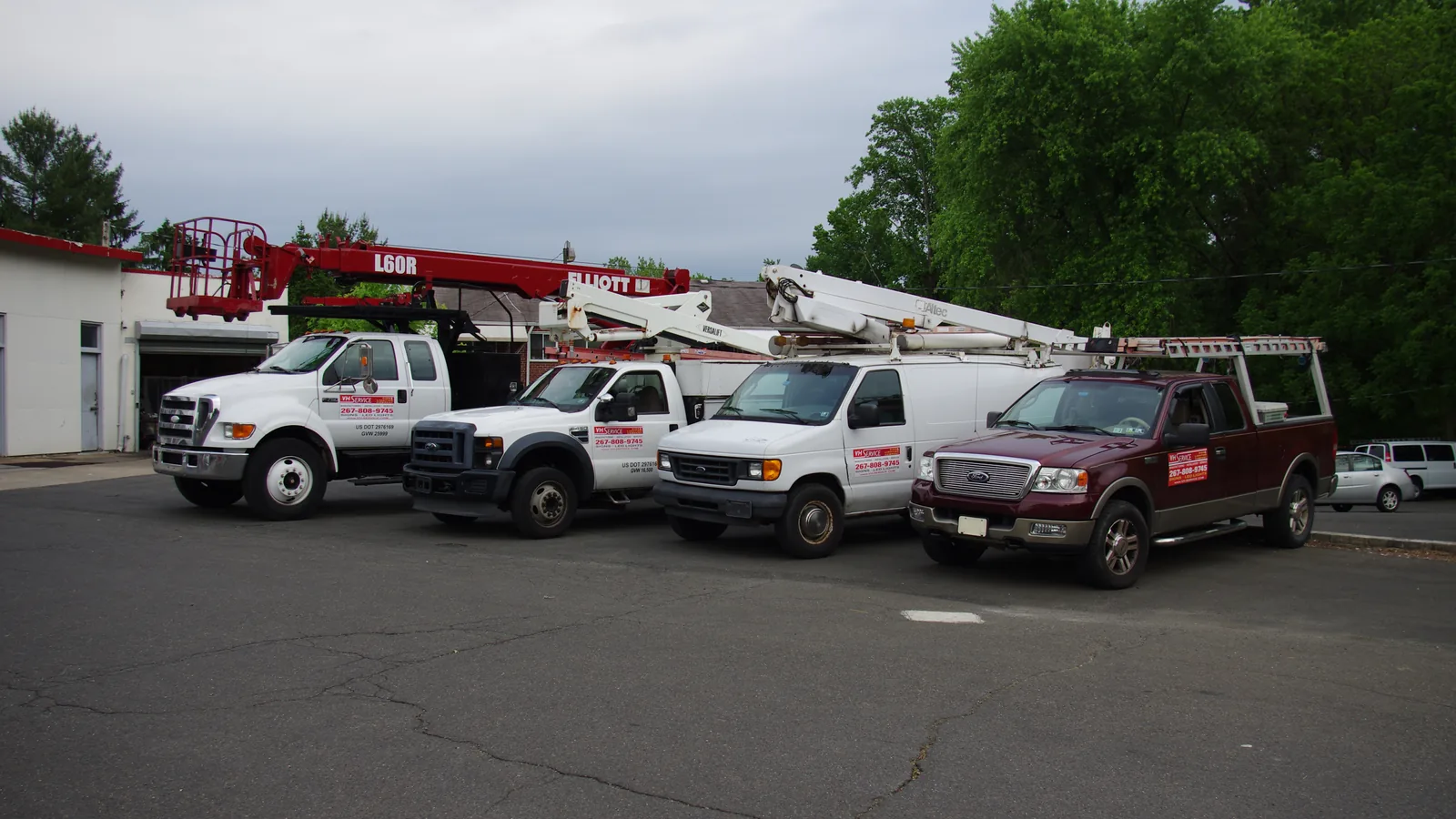 The VH Sign & Lighting truck fleet lined up outside the Woodhaven Road shop