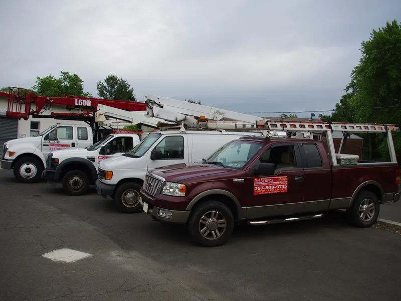 Crew installing front-lit channel letters on a retail storefront in a South Jersey shopping center