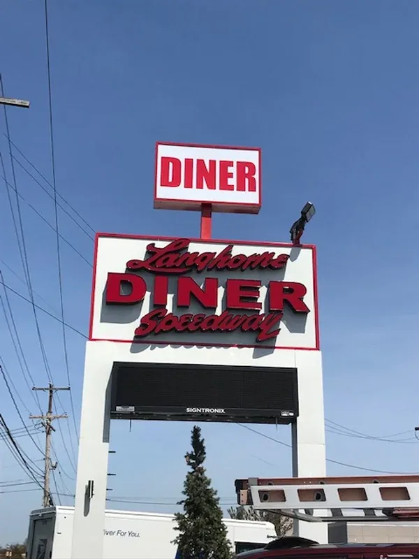 Langhorne Speedway Diner pylon sign: a DINER cabinet on top, the diner name in red lettering on the main cabinet below it, and a full-width LED message board underneath
