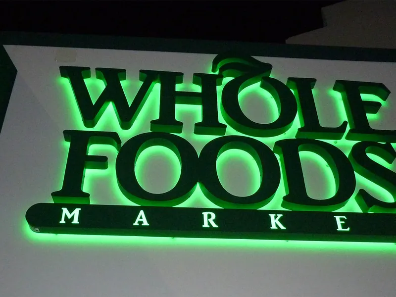 Green illuminated channel letters lit up at night after installation