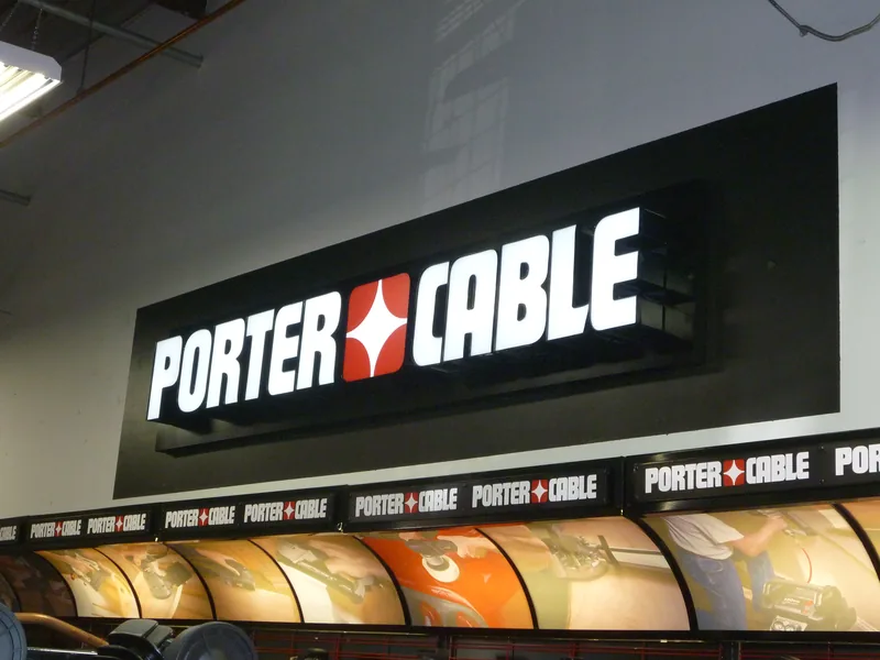 Illuminated Porter Cable channel letters running across a retail storefront fascia
