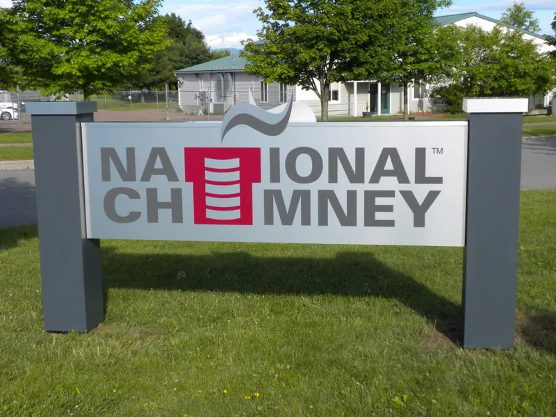National Chimney post-and-panel monument sign standing on a lawn at a property entrance